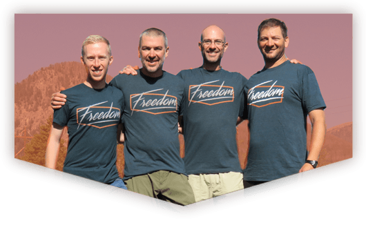four men with exodus 90 t shirts